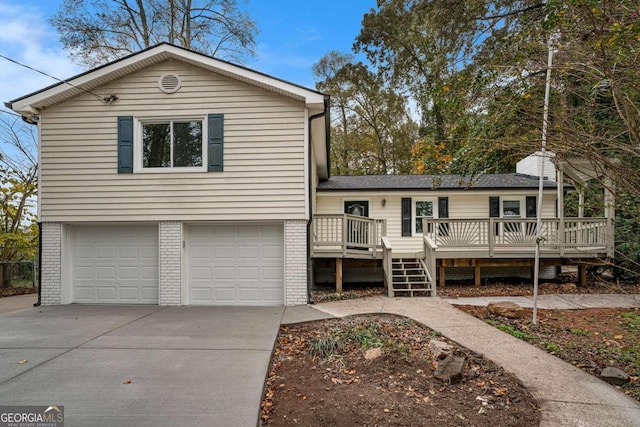 view of front facade with a garage and a wooden deck