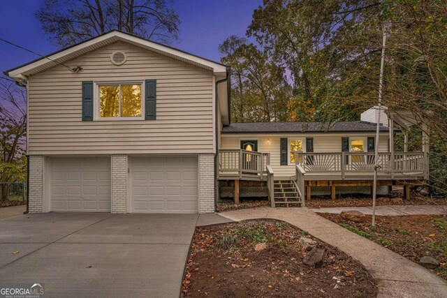 view of front of property featuring a garage and a deck