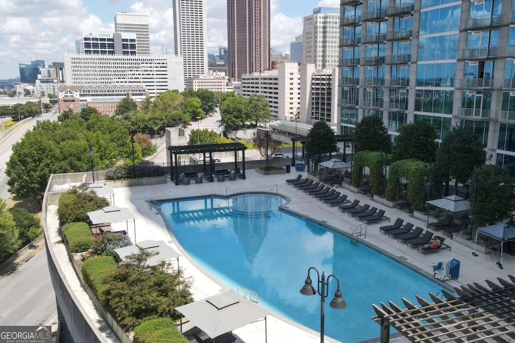 view of swimming pool with a patio area and a pergola