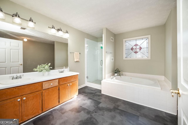 bathroom with vanity, a textured ceiling, and plus walk in shower