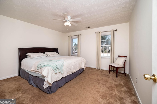 bedroom with carpet flooring, a textured ceiling, and ceiling fan