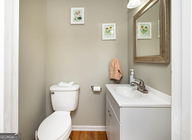 bathroom featuring hardwood / wood-style flooring, vanity, and toilet