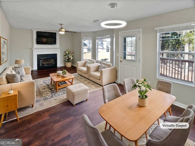 dining room with ceiling fan and dark hardwood / wood-style flooring