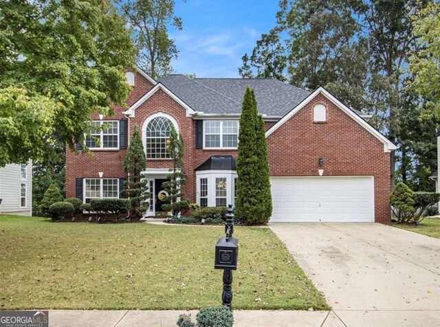 view of front facade featuring a garage and a front yard