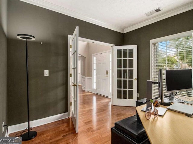 office space featuring french doors, crown molding, and wood-type flooring