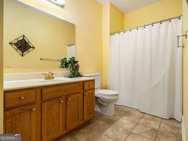 bathroom featuring tile patterned flooring, vanity, and toilet