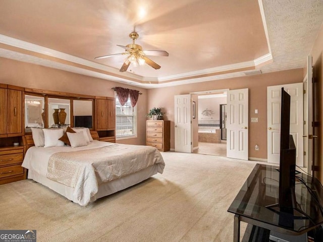 bedroom with a tray ceiling, ceiling fan, and light colored carpet