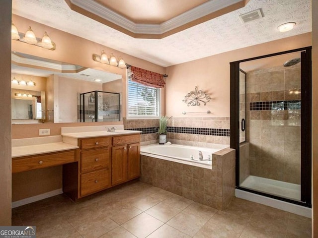 bathroom featuring ornamental molding, vanity, a textured ceiling, a raised ceiling, and shower with separate bathtub