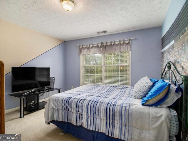 bedroom featuring carpet flooring, a textured ceiling, and vaulted ceiling