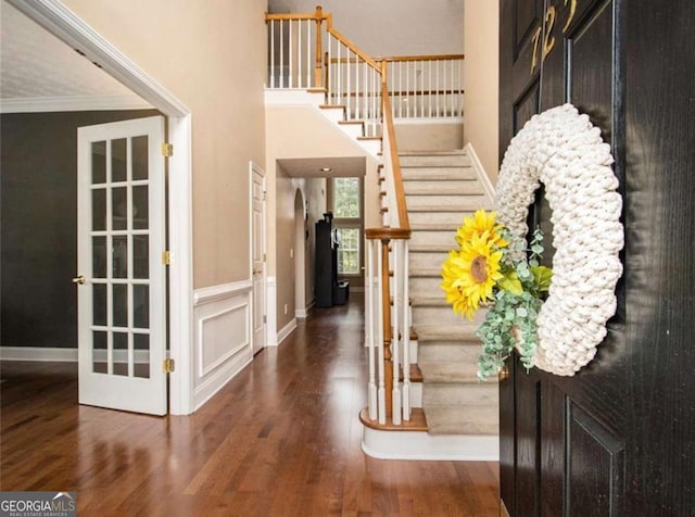 entrance foyer featuring dark hardwood / wood-style floors and ornamental molding