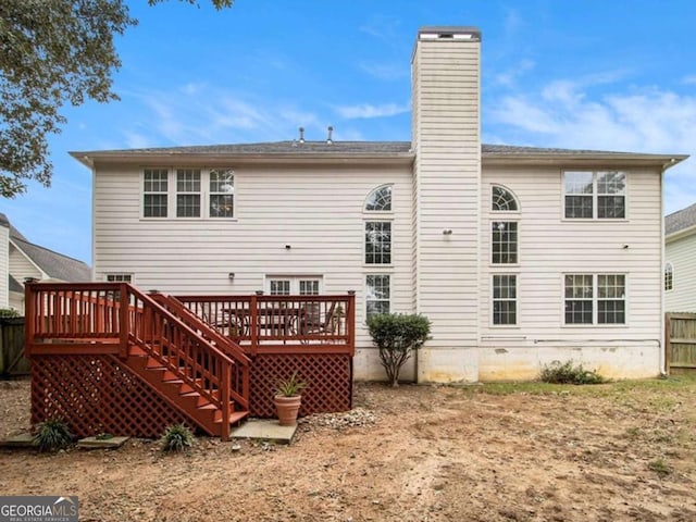 rear view of property featuring a wooden deck