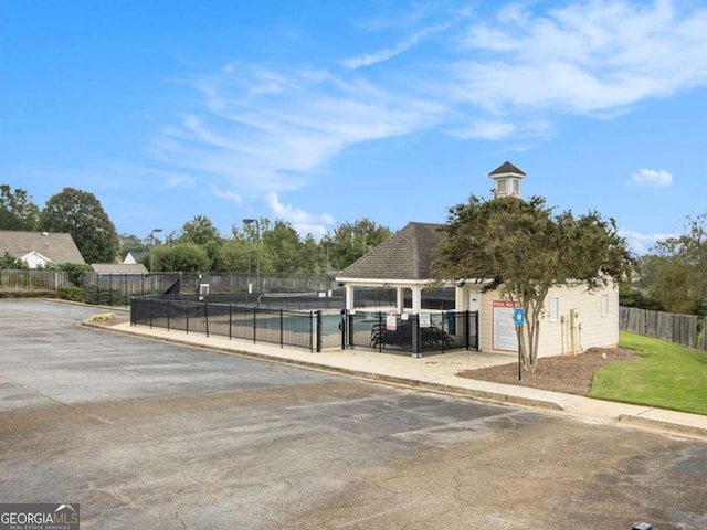 view of vehicle parking with a community pool