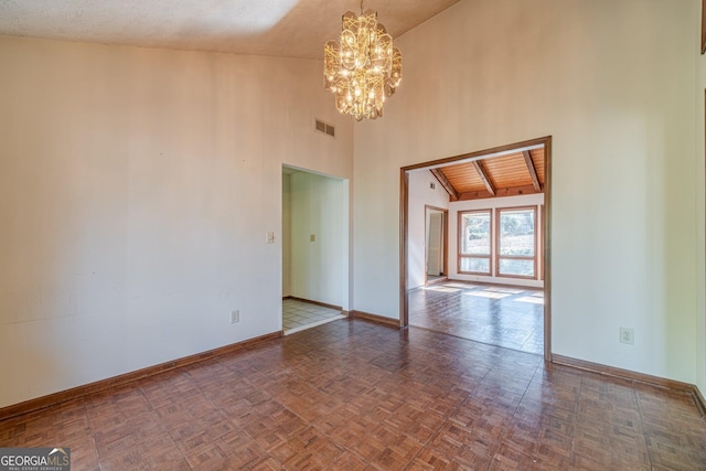 empty room with an inviting chandelier, dark parquet flooring, lofted ceiling, and wood ceiling