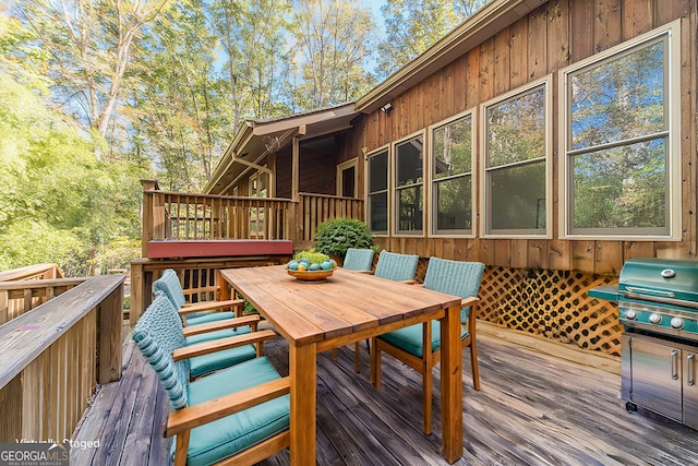 wooden terrace featuring grilling area