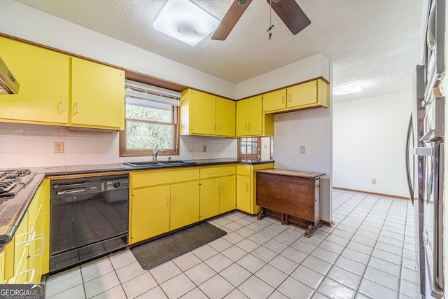 kitchen featuring dishwasher, fridge, sink, light tile patterned floors, and a textured ceiling