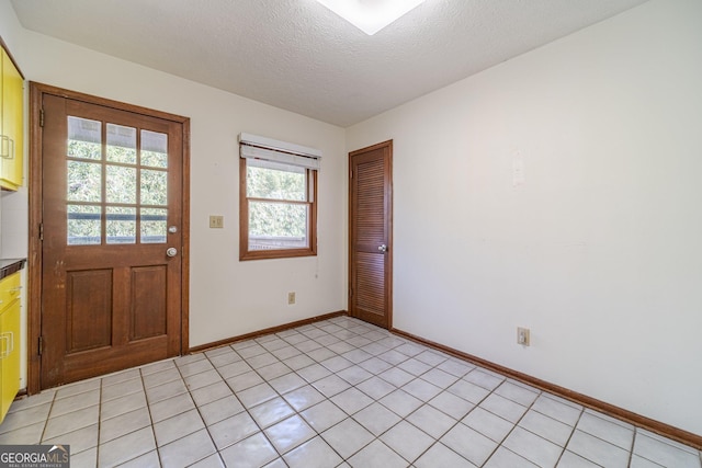 tiled foyer featuring a textured ceiling