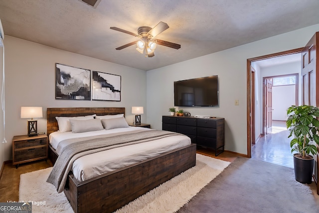 bedroom featuring ceiling fan and a textured ceiling