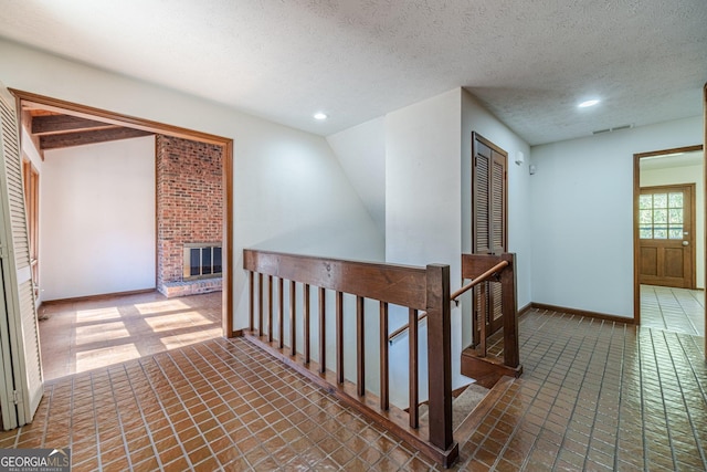 hall with a textured ceiling