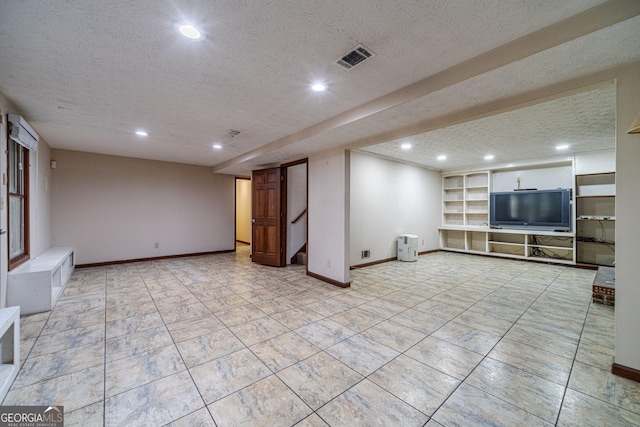 unfurnished living room featuring a textured ceiling