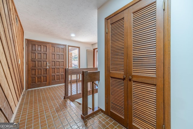 hallway featuring a textured ceiling