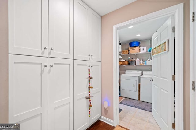 washroom featuring washer and dryer and light tile patterned floors