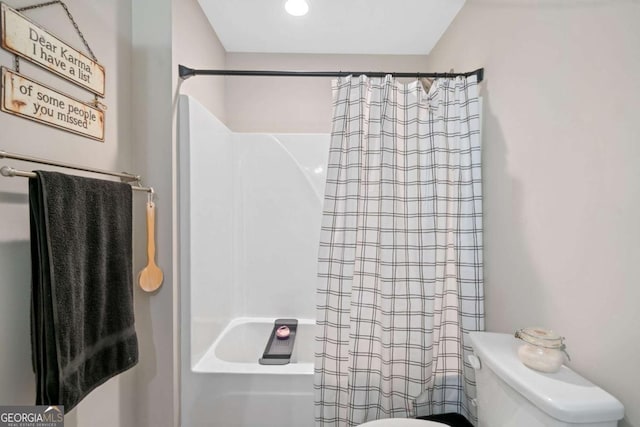 bathroom featuring shower / bath combination with curtain and toilet