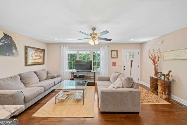 living room with ceiling fan and dark hardwood / wood-style flooring