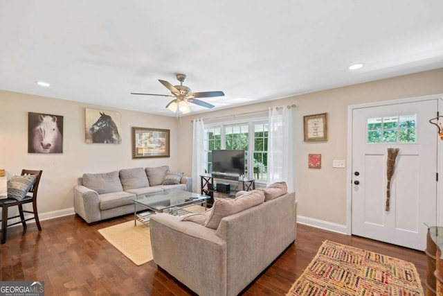 living room with dark hardwood / wood-style floors and ceiling fan