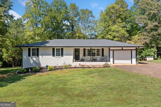 ranch-style house featuring covered porch, a garage, and a front lawn