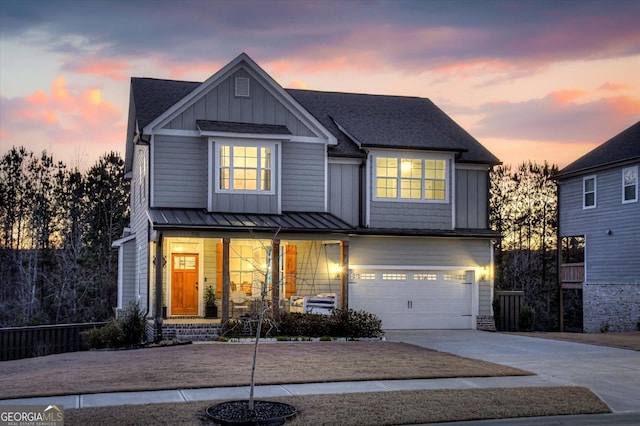 view of front of house with covered porch and a garage