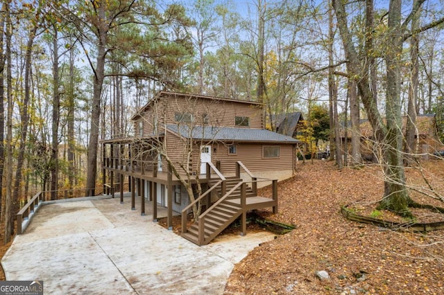 rear view of house featuring a deck