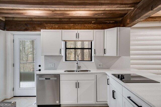 kitchen with black electric stovetop, sink, stainless steel dishwasher, beamed ceiling, and white cabinetry