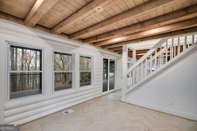 unfurnished sunroom featuring beam ceiling and wood ceiling