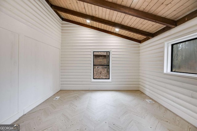 empty room with lofted ceiling with beams, wooden ceiling, and light parquet flooring