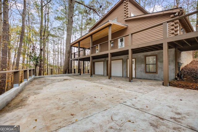 view of property exterior featuring a balcony and a garage