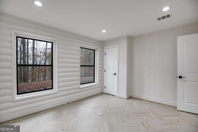 spare room with light parquet flooring and ornamental molding