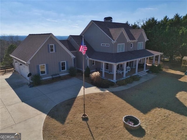 view of front facade with a garage, covered porch, and a front lawn