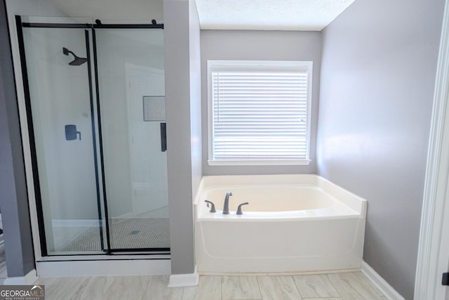 bathroom featuring plus walk in shower and a wealth of natural light