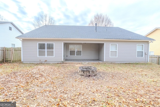 back of house with an outdoor fire pit