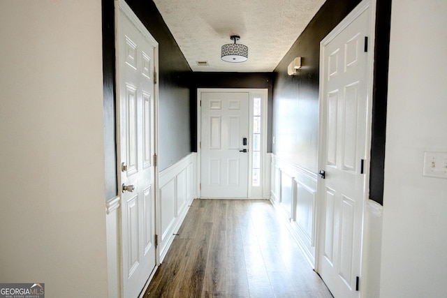 doorway to outside featuring hardwood / wood-style floors and a textured ceiling