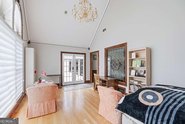 bedroom with a notable chandelier, light wood-type flooring, high vaulted ceiling, and french doors