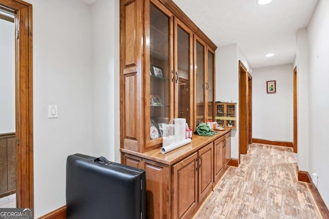 hall with light hardwood / wood-style flooring