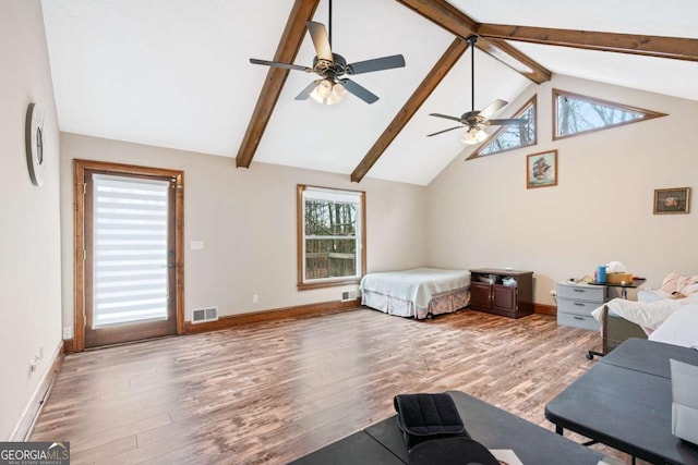 bedroom featuring hardwood / wood-style floors, ceiling fan, and vaulted ceiling with beams