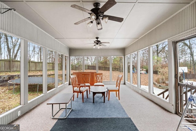 sunroom / solarium featuring ceiling fan