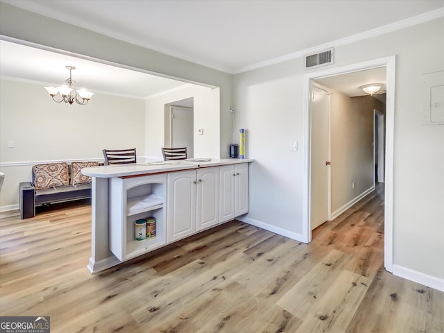 6520 Roswell Rd Unit 59, Sandy Springs, GA 30328 - kitchen with white cabinetry, crown molding, a chandelier, light wood-type flooring, and open shelves