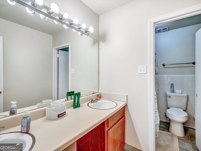 6520 Roswell Rd Unit 59, Sandy Springs, GA 30328 - full bath with double vanity, tile patterned flooring, tile walls, and wainscoting