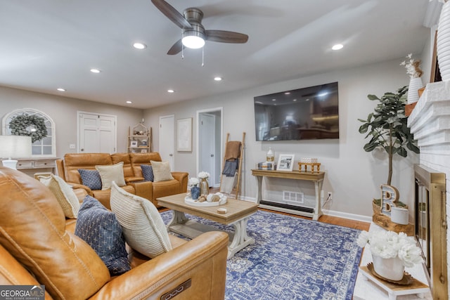 living room with hardwood / wood-style flooring and ceiling fan