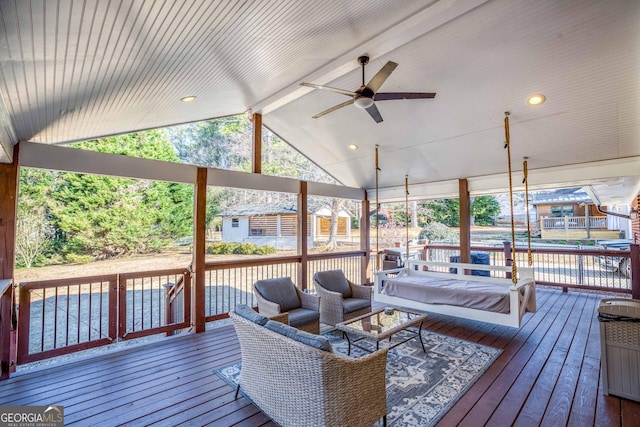 wooden terrace with an outdoor hangout area and ceiling fan