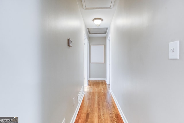 hallway with light hardwood / wood-style floors