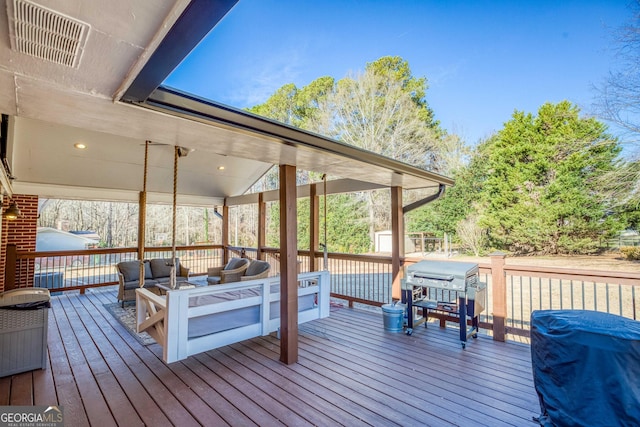 deck featuring outdoor lounge area and grilling area